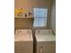 Bright laundry room with washer, dryer, and shelves ready for use at 5309 Luna Bonita St, Las Vegas, NV 89113