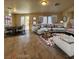 Bright and airy living room featuring tile floors, a comfortable sofa, and access to the backyard at 5309 Luna Bonita St, Las Vegas, NV 89113