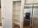 Pantry with shelving next to stainless steel refrigerator at 5309 Luna Bonita St, Las Vegas, NV 89113