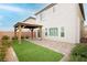 Backyard featuring a gazebo on a brick patio next to a patch of artifical grass at 5384 Knitmore Ct, Las Vegas, NV 89139