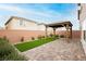 Backyard featuring a gazebo on a brick patio next to a patch of artifical grass at 5384 Knitmore Ct, Las Vegas, NV 89139