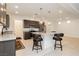 Open kitchen with granite counters, stainless appliances, and seating at the large center island at 5384 Knitmore Ct, Las Vegas, NV 89139