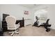 Bright, carpeted office space with desk, chair, and stationary bicycle near a window at 5384 Knitmore Ct, Las Vegas, NV 89139