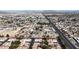 Expansive aerial view displays the neighborhood, street, and nearby mountains in the distance at 5401 Tassara Way # 102, Las Vegas, NV 89108