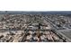 Extensive aerial view showcasing a dense residential area with diverse housing and commercial zones, plus accessible roads and city skyline at 5401 Tassara Way # 102, Las Vegas, NV 89108