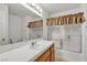 Bright bathroom with a framed mirror, vanity, and shower-tub combination at 5401 Tassara Way # 102, Las Vegas, NV 89108