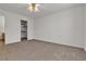 Bedroom featuring neutral carpet and a walk in closet with shelving at 5401 Tassara Way # 102, Las Vegas, NV 89108