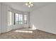 Bright bedroom featuring neutral carpet, large windows, and a ceiling fan at 5401 Tassara Way # 102, Las Vegas, NV 89108