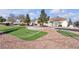 Putting green in the Smoke Ranch Villa community with landscaped lawns and nearby homes at 5401 Tassara Way # 102, Las Vegas, NV 89108