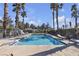 Large community pool with lounge chairs and palm trees offering a resort-style experience at 5401 Tassara Way # 102, Las Vegas, NV 89108