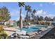 Community pool with lounge chairs and tables provides relaxation and recreation at 5401 Tassara Way # 102, Las Vegas, NV 89108