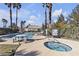 Community pool and spa with tables and chairs for relaxing poolside at 5401 Tassara Way # 102, Las Vegas, NV 89108