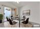 Staged dining room featuring a glass table, six chairs, ceiling fan, and sliding doors at 5401 Tassara Way # 102, Las Vegas, NV 89108