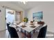 Tastefully staged dining room with seating for six, a ceiling fan, and sliding glass doors at 5401 Tassara Way # 102, Las Vegas, NV 89108
