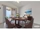 Inviting staged dining room with seating for six, complemented by a ceiling fan and sliding glass doors at 5401 Tassara Way # 102, Las Vegas, NV 89108