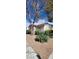 Inviting single-story home with desert landscaping and a terracotta tile roof at 5401 Tassara Way # 102, Las Vegas, NV 89108