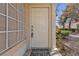Welcoming front entrance with a white door, sidelight and a 'Welcome' mat at 5401 Tassara Way # 102, Las Vegas, NV 89108