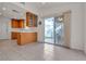 Eat-in kitchen with tile floors and sliding glass door leading to outdoor space at 5401 Tassara Way # 102, Las Vegas, NV 89108