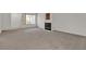 Large, bright living room with plush carpet and cozy fireplace ready for personalization at 5401 Tassara Way # 102, Las Vegas, NV 89108