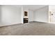 Spacious living room with neutral carpeting, a cozy fireplace, and ample natural light at 5401 Tassara Way # 102, Las Vegas, NV 89108