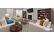 Bright living room featuring a fireplace, bookshelves, and comfortable seating area at 5401 Tassara Way # 102, Las Vegas, NV 89108
