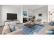 Well-designed living room with a mounted TV, fireplace and comfortable furnishings at 5401 Tassara Way # 102, Las Vegas, NV 89108