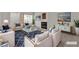 Living room featuring stylish furniture, a fireplace, and ample natural light at 5401 Tassara Way # 102, Las Vegas, NV 89108