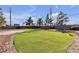 Community putting green with well-maintained turf, ready for golfers to practice their putting skills at 5401 Tassara Way # 102, Las Vegas, NV 89108