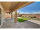 Relaxing covered back patio overlooks a manicured backyard at 5518 Taylor Rose Ave, Las Vegas, NV 89139