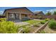 Spacious backyard featuring a covered patio and colorful landscaping at 5518 Taylor Rose Ave, Las Vegas, NV 89139