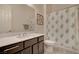 Bathroom showcases a stylish vanity, a shower with a cactus-themed curtain, and tile flooring at 5518 Taylor Rose Ave, Las Vegas, NV 89139