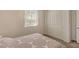 Comfortable carpeted bedroom with a sun-drenched window and a spacious closet at 5518 Taylor Rose Ave, Las Vegas, NV 89139