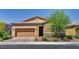 Inviting single-story home with a two-car garage, desert landscaping, and brick-paved driveway at 5518 Taylor Rose Ave, Las Vegas, NV 89139