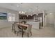 Kitchen with stainless steel appliances, dark cabinetry, and a large island overlooks the dining area at 5518 Taylor Rose Ave, Las Vegas, NV 89139