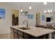 The kitchen island with stainless steel sink overlooks the dining area and a full pantry at 5518 Taylor Rose Ave, Las Vegas, NV 89139