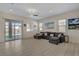 Bright living room featuring a comfortable sectional sofa and sliding door to the backyard at 5518 Taylor Rose Ave, Las Vegas, NV 89139