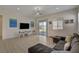 Open living room with tile floors, backyard views and a comfortable sectional sofa at 5518 Taylor Rose Ave, Las Vegas, NV 89139