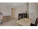 Spacious home office with tiled floors, a minimalist desk, and natural lighting at 5518 Taylor Rose Ave, Las Vegas, NV 89139
