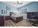 Stylish bedroom featuring a dark wood bed frame, ceiling fan and plantation shutters at 5523 Taylor Rose Ave, Las Vegas, NV 89139