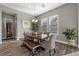 Traditional dining room features wood floors, chandelier and wine fridge at 5523 Taylor Rose Ave, Las Vegas, NV 89139