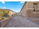 Long driveway with brick pavers leading to a gated courtyard and three car garage at 5523 Taylor Rose Ave, Las Vegas, NV 89139