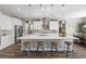 Kitchen with white cabinets, large island, stainless appliances and wood floors at 5523 Taylor Rose Ave, Las Vegas, NV 89139