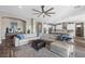 Spacious living room with a large sectional couch, fireplace, and open-concept kitchen at 5523 Taylor Rose Ave, Las Vegas, NV 89139