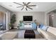 Living room features hardwood floors, a large couch and a ceiling fan at 5523 Taylor Rose Ave, Las Vegas, NV 89139