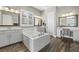 Bright primary bath featuring a soaking tub, vanity, and tile floors at 5523 Taylor Rose Ave, Las Vegas, NV 89139