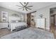 Stylish primary bedroom featuring a barn door entry into the bathroom, ceiling fan and natural light at 5523 Taylor Rose Ave, Las Vegas, NV 89139