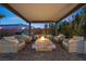 Inviting outdoor patio with cozy seating arranged around a fire pit, creating a perfect gathering space at 5523 Taylor Rose Ave, Las Vegas, NV 89139