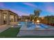 Backyard view of a refreshing pool, spa, and covered patio with a fire pit, perfect for outdoor entertainment at 5523 Taylor Rose Ave, Las Vegas, NV 89139