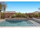 A modern pool and spa combination, accented by stylish fire bowls and lush landscaping for relaxation at 5523 Taylor Rose Ave, Las Vegas, NV 89139