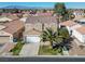 An aerial view of a desert home with a red tile roof and desert landscaping at 5854 Heather Marie Dr, Las Vegas, NV 89110